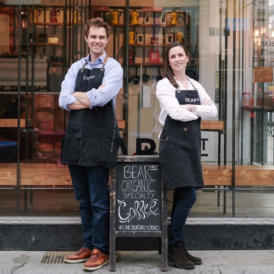 two people outside a cafe