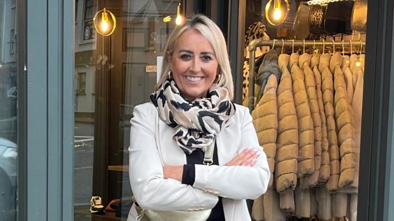 woman standing in front of shop